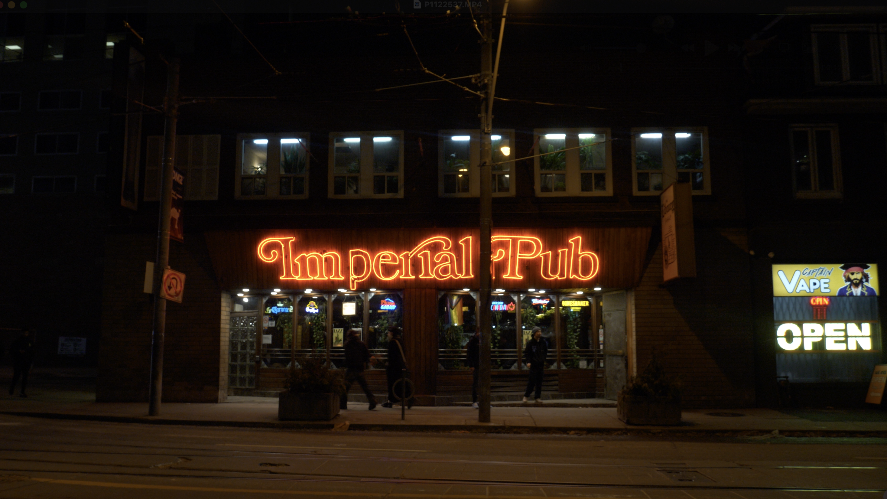 Red glowing neon sign above the Imperial Pub