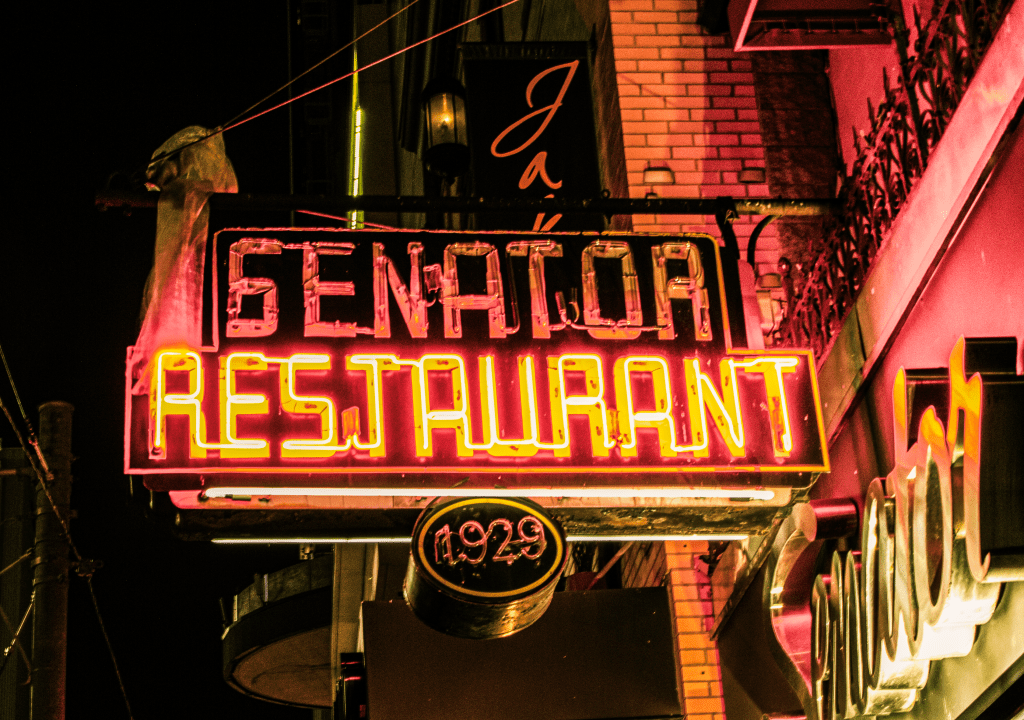 Red glowing neon sign above the senator restaurant